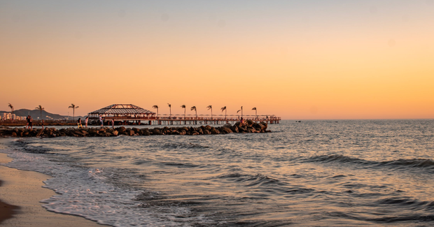 Sunset beach looking at a pier