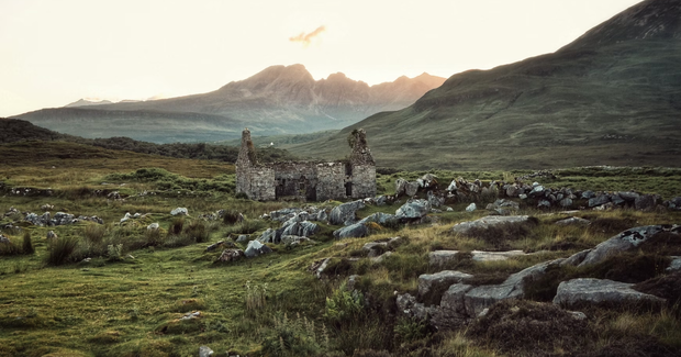 old stone house in a field