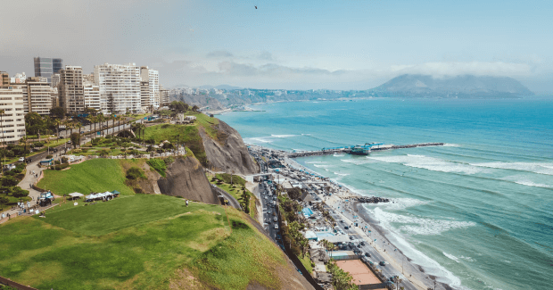 City highrises perched along a cliff overlooking ocean